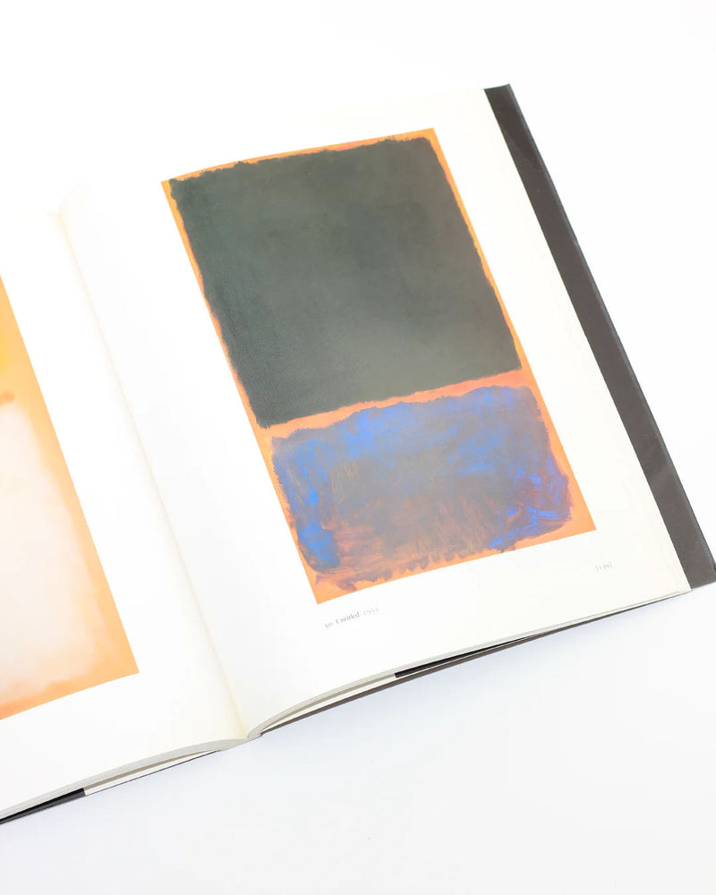 Open Mark Rothko art book showing abstract color field painting