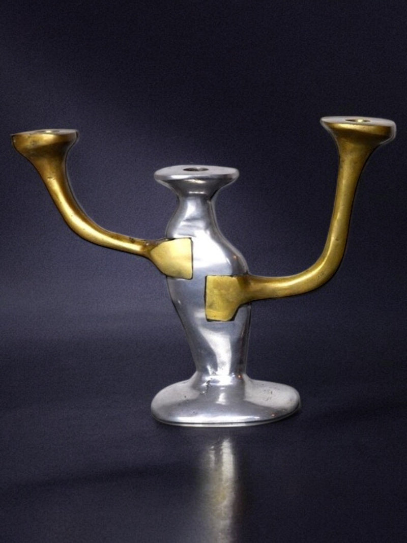 Brutalist candleholder with bronze curved arms and silver base detail