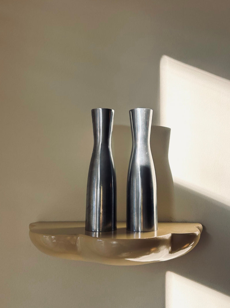 Polished steel candlesticks with modern design for elegant table setting