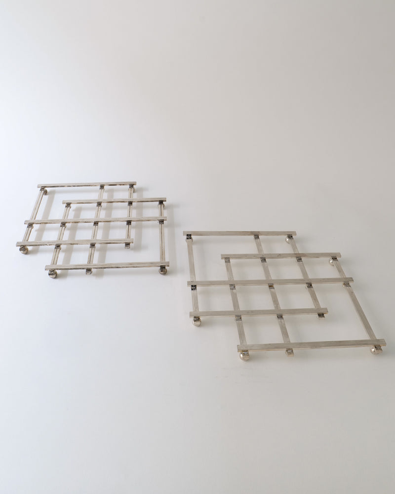 Two silver metal trivets with grid pattern design from 1950s