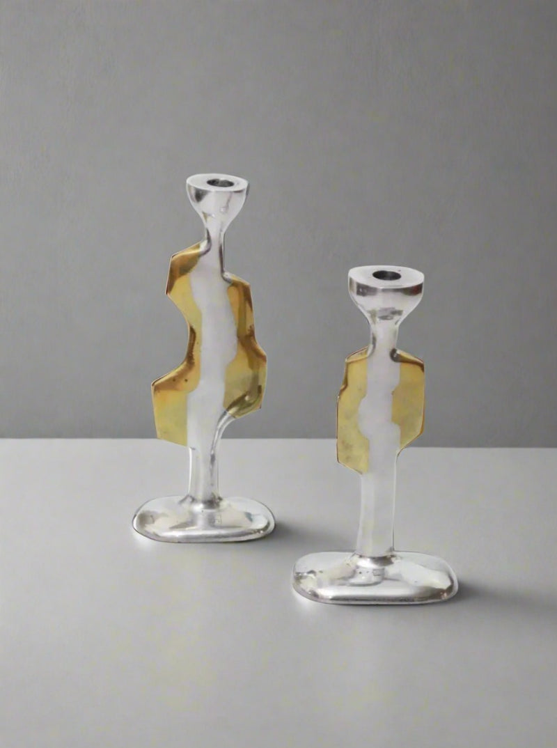 Pair of Brutalist Candleholders in distressed black finish on white background