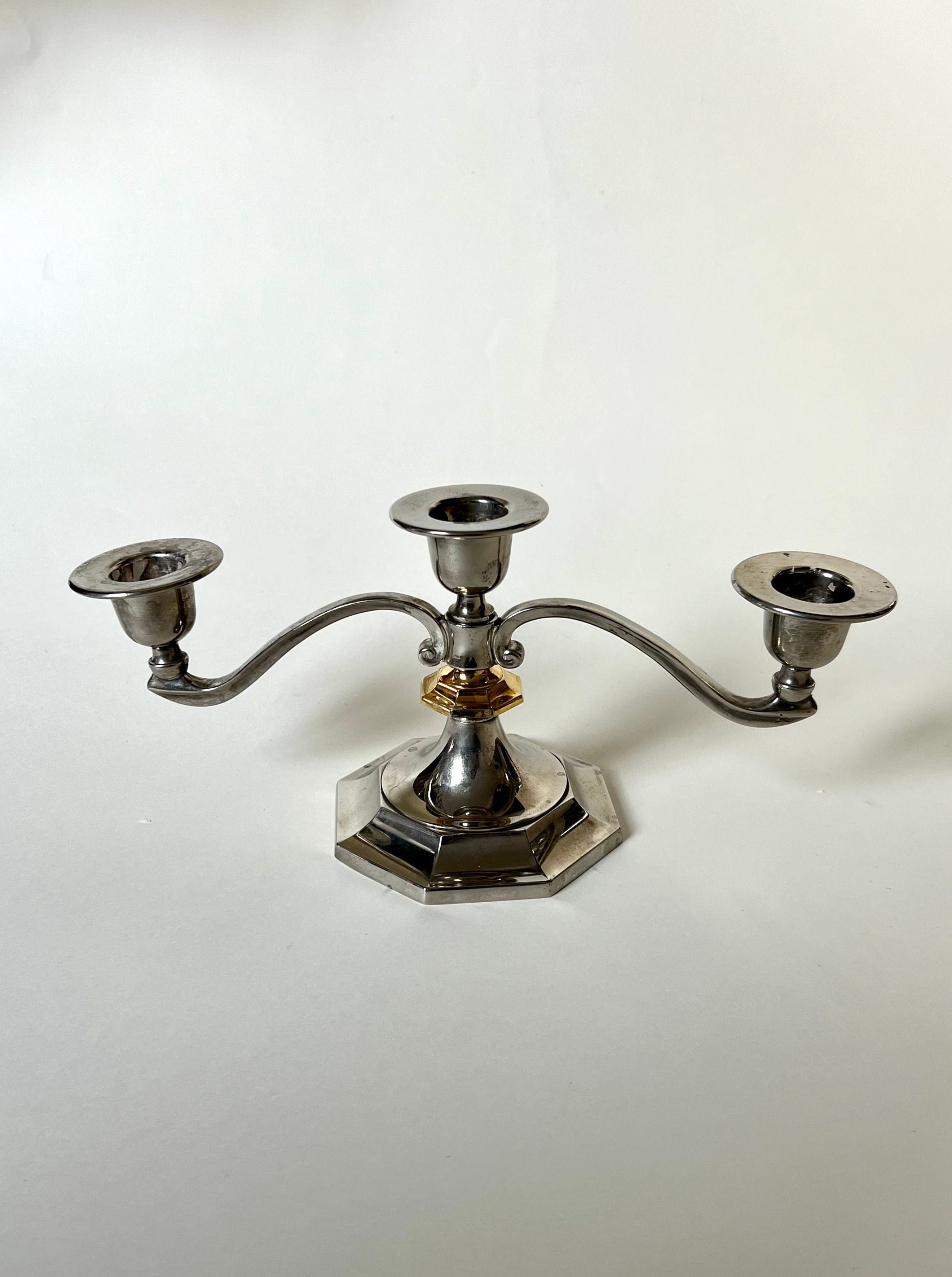 ###
A sleek and elegant silver and gold candleholder set for home decor