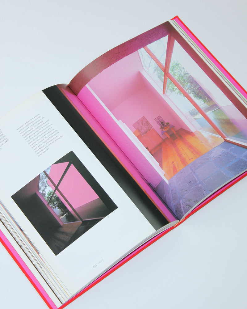 Open Casa Barragan architecture book showing colorful interior pages