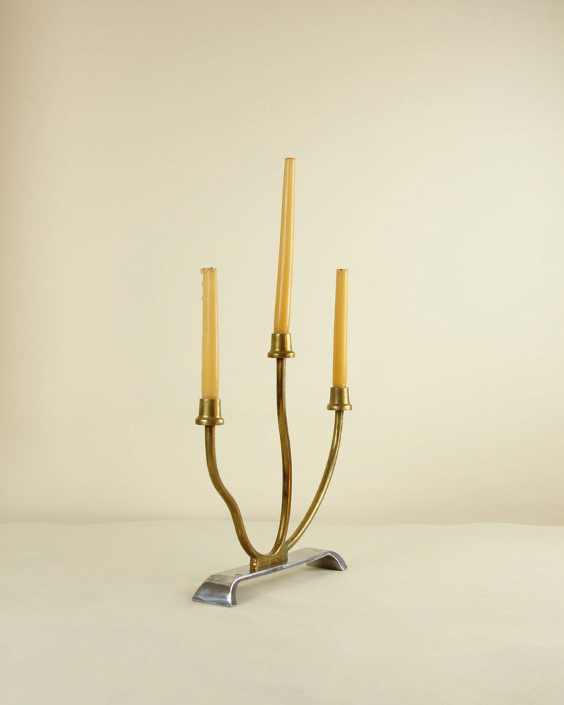 Three-arm brass and aluminum candleholder with cream candles