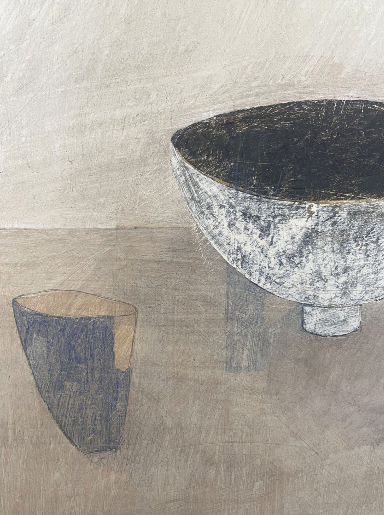 'A minimalist still life painting features a textured, large, gray bowl with dark interior on a light beige surface. Next to it is a smaller, abstract, geometric object with similar color tones and textures. The background is a soft gradient of beige and gray, painted in acrylic on cradled wooden panel.' is an accurate depiction of the 'Ansoku' Painting by Lara Voce.