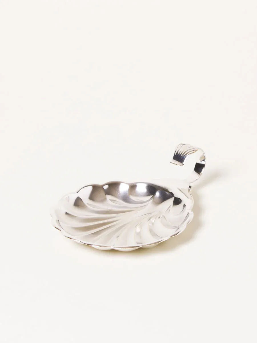 Shiny small silver dish with a decorative handle, perfect for serving