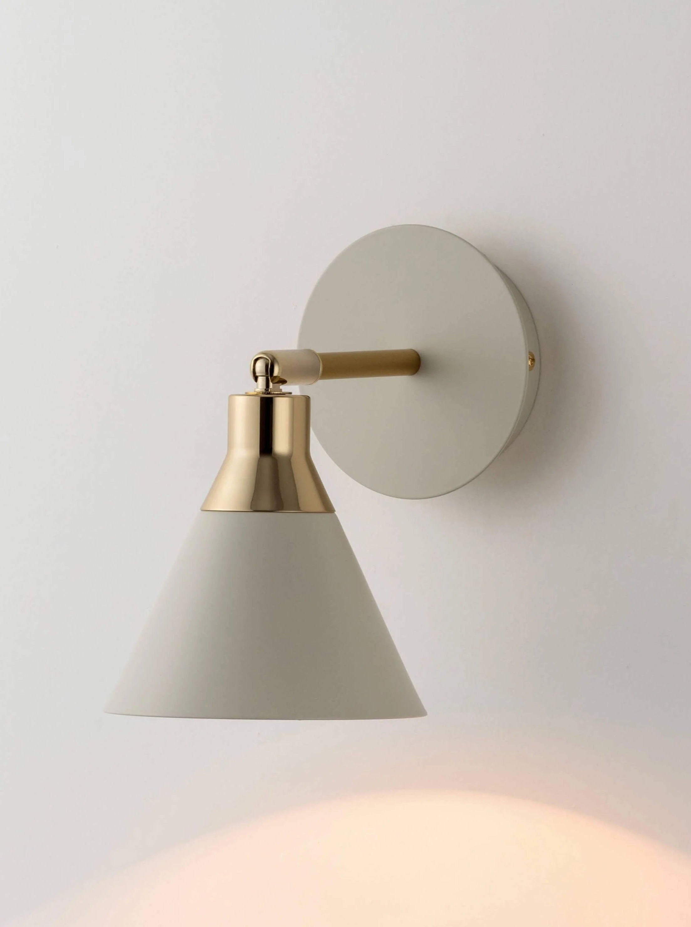 Modern sand cone wall light fixture with sleek design and soft illumination