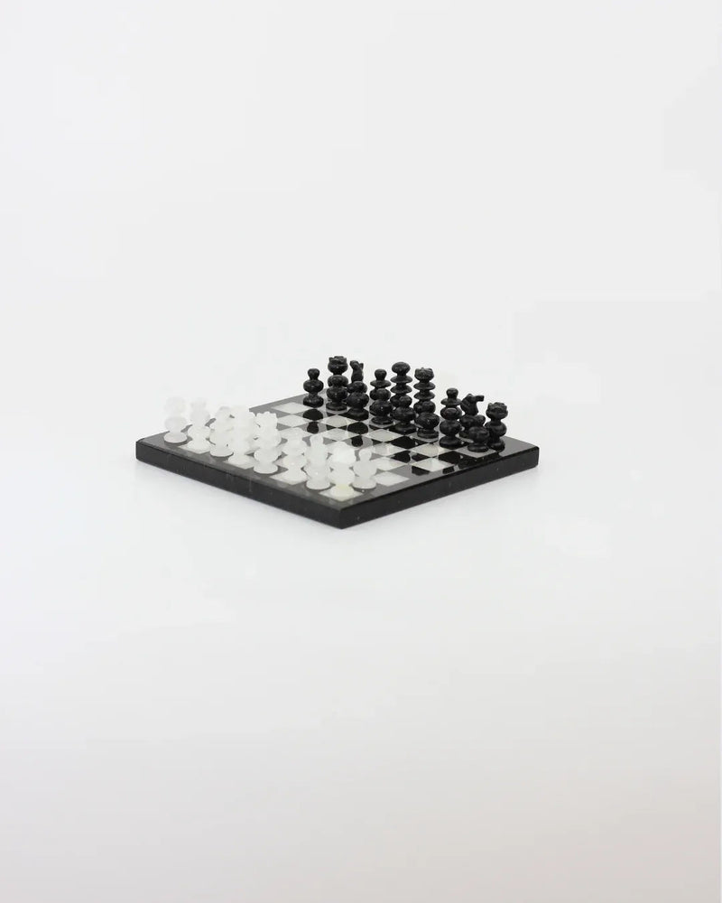 The Boga Avante Shop's Handmade Chess Board in onyx showcases hand-carved pieces elegantly placed on an onyx board, set against a plain white background.