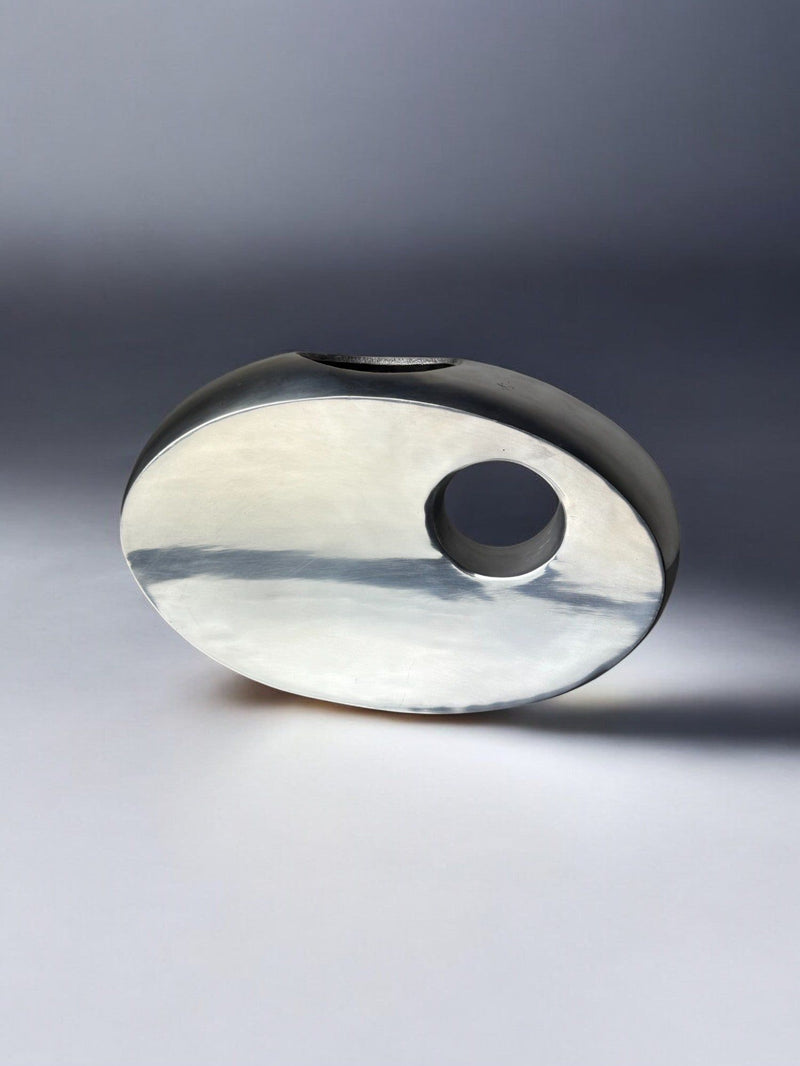 Biomorphic aluminum vase profile view showing curved opening detail