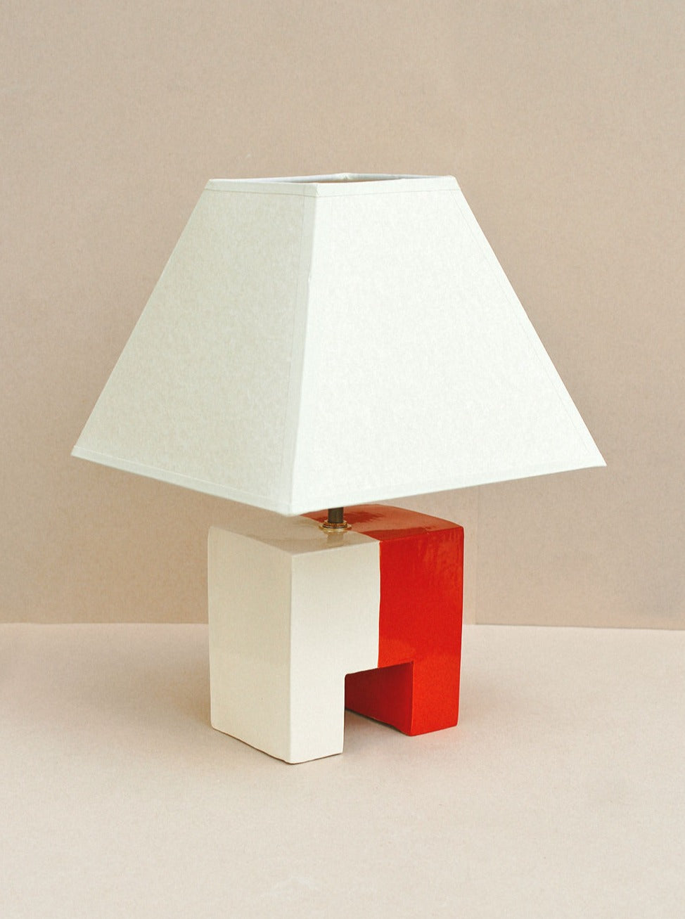 A stunning Cristo Lamp in red and cream colors, perfect for adding a touch of elegance to any room