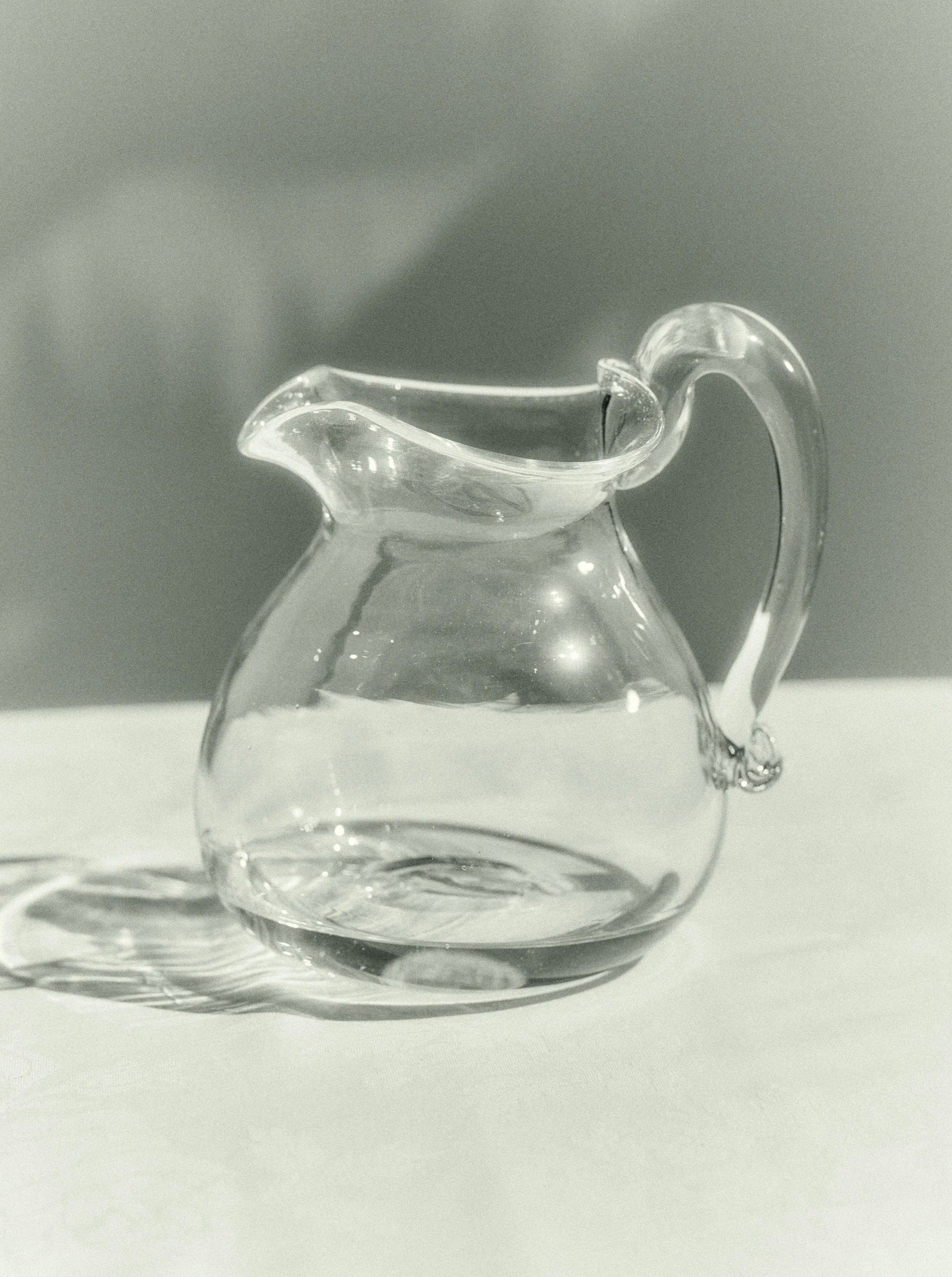 Large, clear glass Michele Jug with a sturdy handle and pour spout