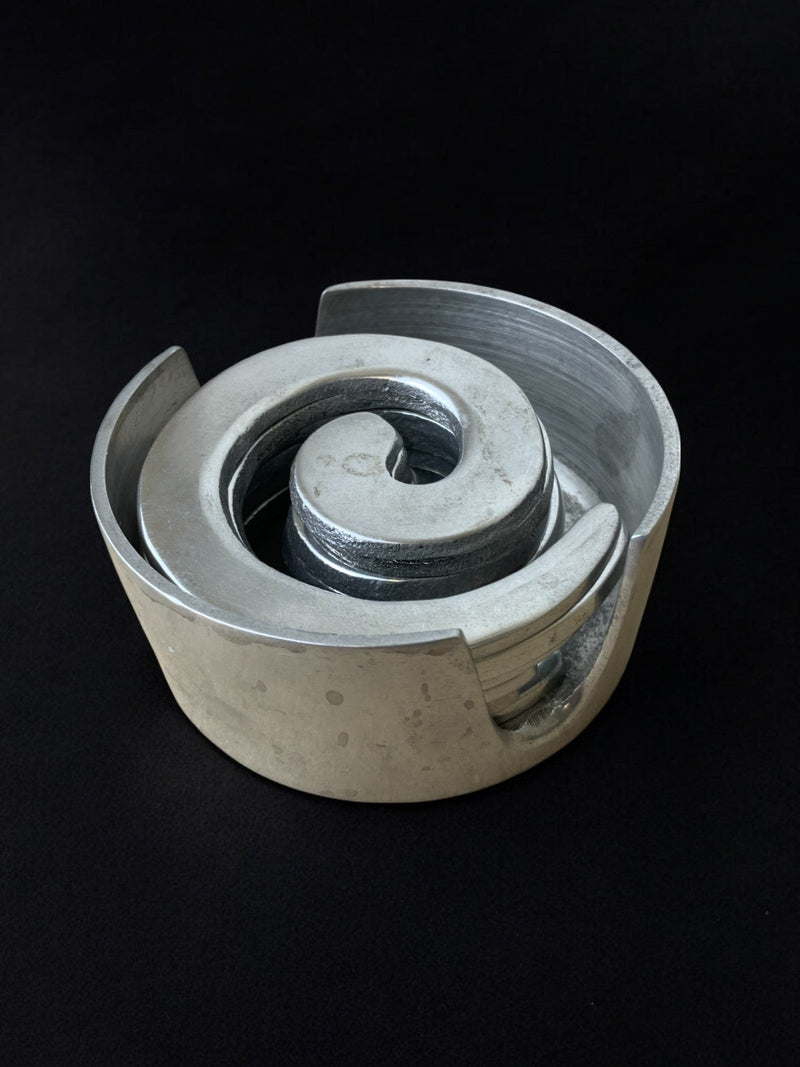 Spiral aluminum coasters stacked detail showing biomorphic curves