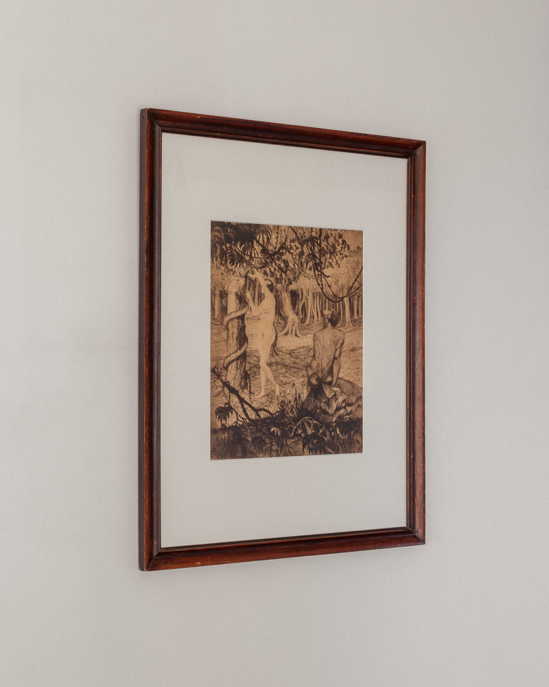 The Adam & Eve etching by Gaston Smidt, crafted in the 1900s and offered by Spigel, features a sepia-toned depiction of a woman by a riverbank with trees. The timeless appeal of the dry-needle technique is enhanced by its wooden frame, making it perfect for any wall.