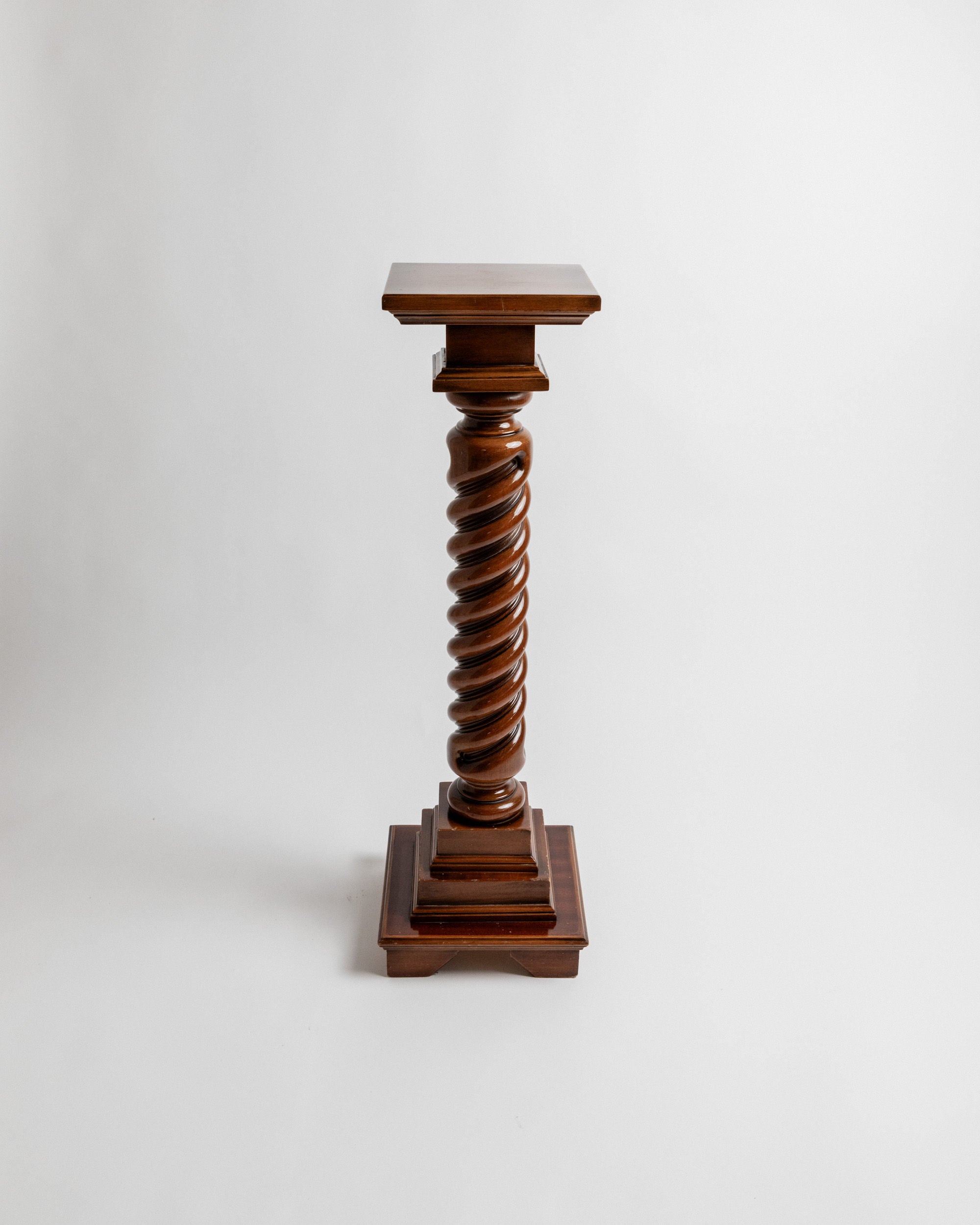 The Bottega Jacobs Wooden Stand from Italy's 1960s is a vintage piece featuring a twisted column design with a square base and top. Handcrafted from solid wood, it stands elegantly against a plain white background.