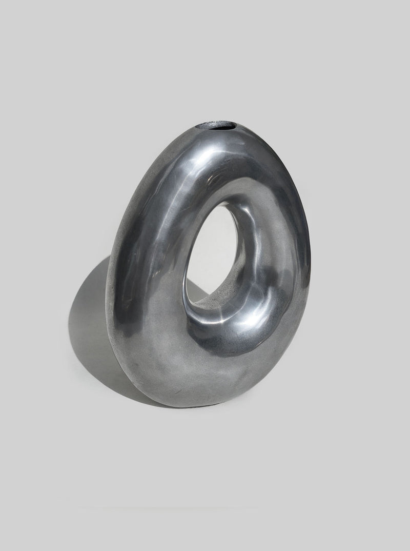 Sculptural grey ceramic vase with flowing curved form and opening