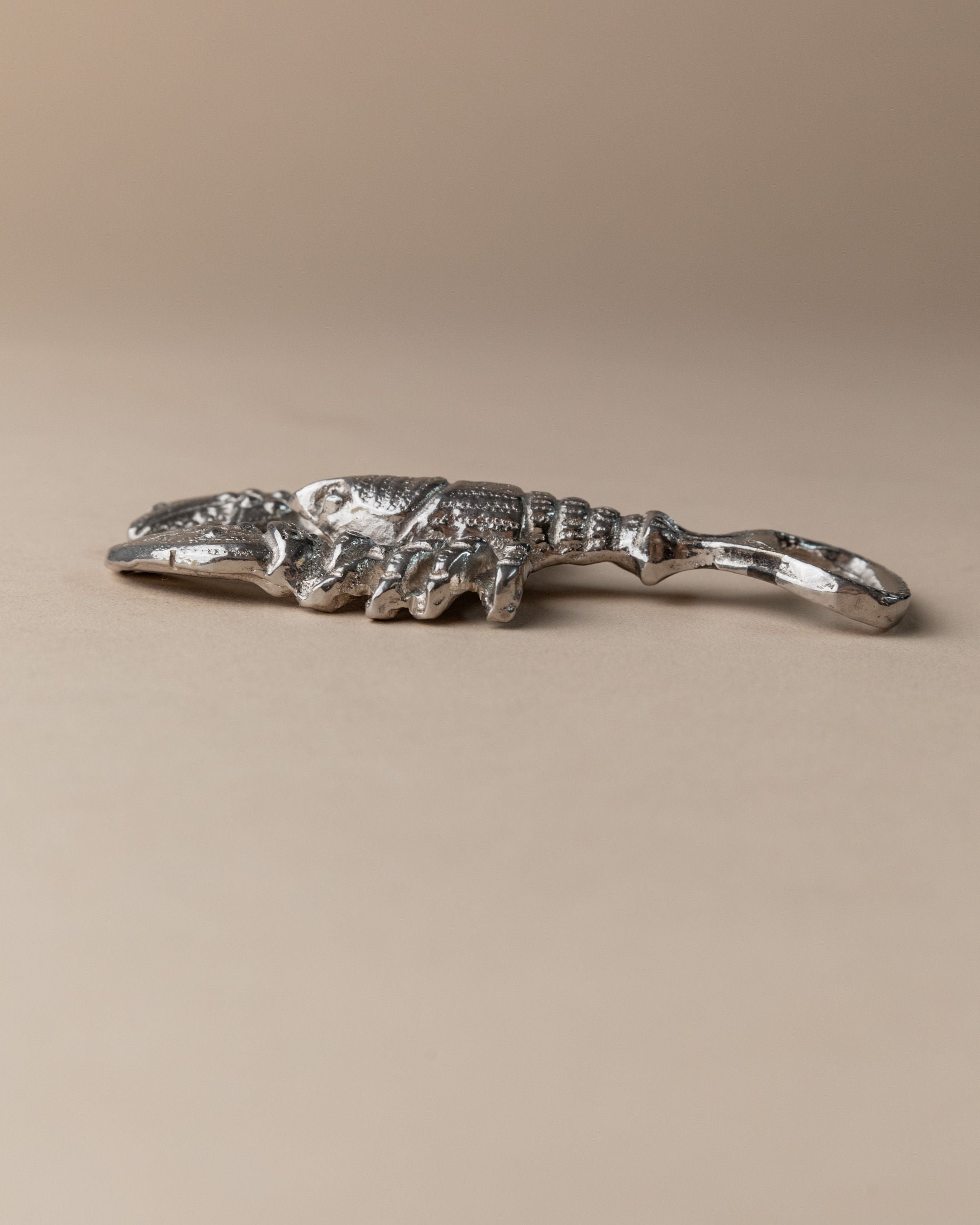 Silver plated crocodile bottle opener lying flat, Italy 1960s