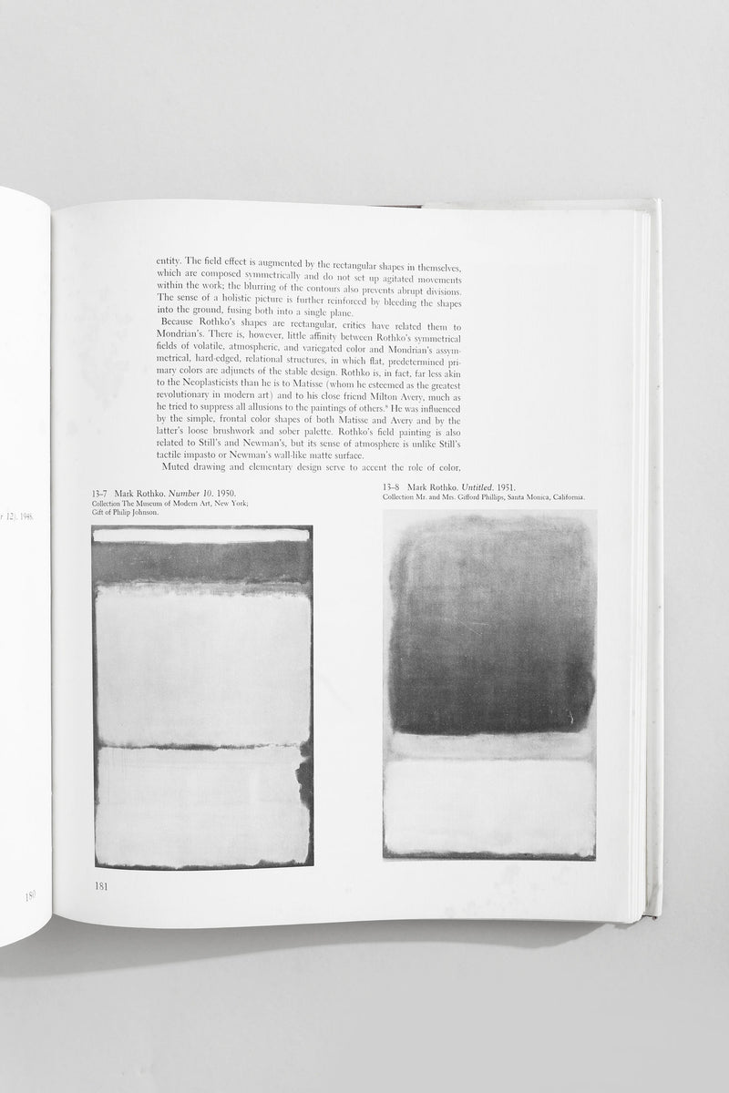 Open art book showing Mark Rothko color field paintings with text