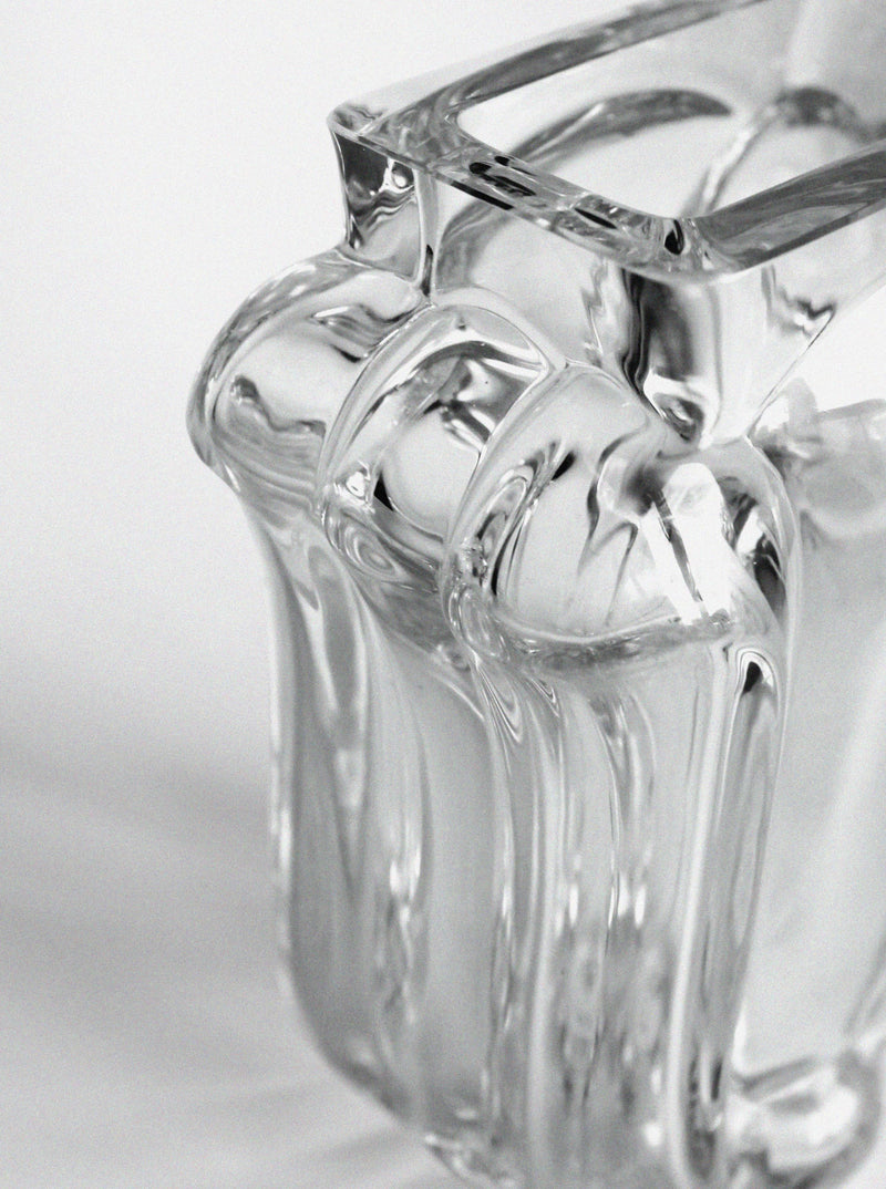 Close-up of the Lars Hellsten "Tulip" Crystal Glass Vase by Vintage Stories, showcasing smooth, flowing curves and intricate reflections against a plain white background.