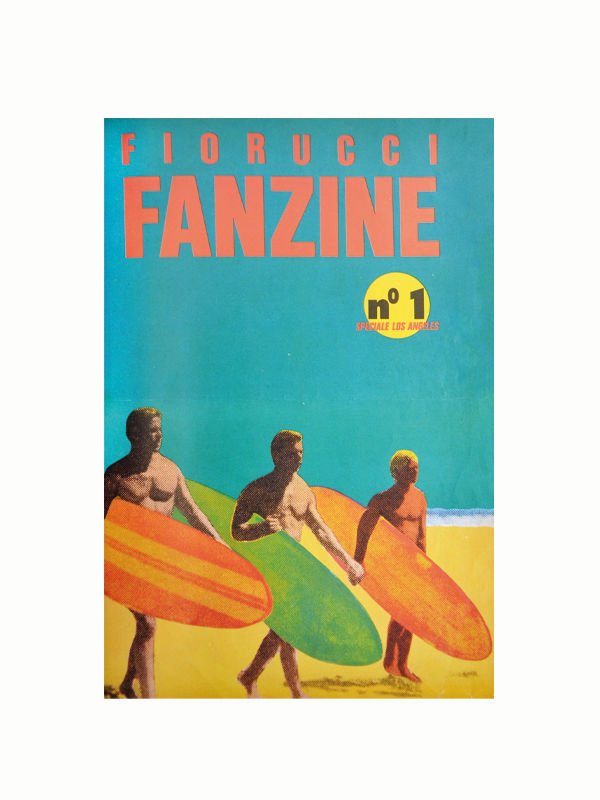 Three people holding surfboards walk along a beach. The image has a vibrant, vintage style with a bright blue sky and yellow sand. The text at the top reads "MAISON PLAGE" in orange and below it "No 1 SPECIALE LOS ANGELES" in yellow, capturing the essence of 1980s fashion from this iconic brand.