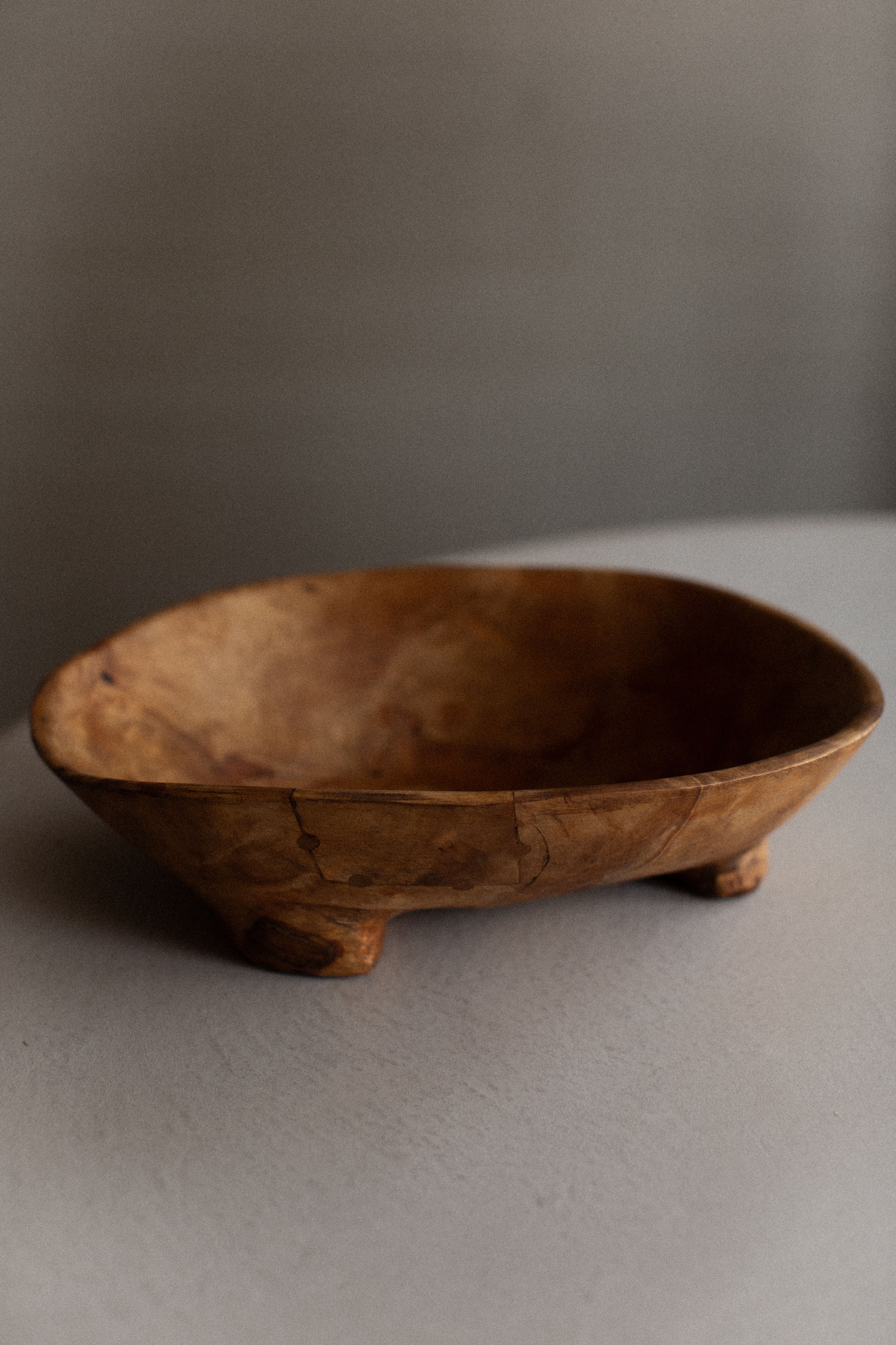 Alt text: Rustic vintage wooden bowl with hand-carved details and warm patina