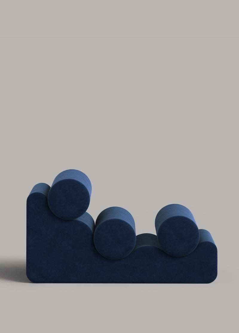 Blue velvet modular sofa with cylindrical cushions, front view