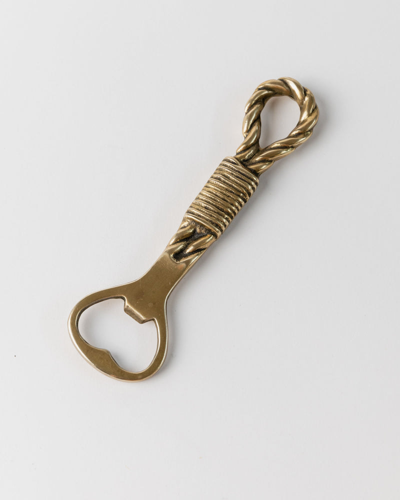 Twisted brass bottle opener handle detail with rope-like design