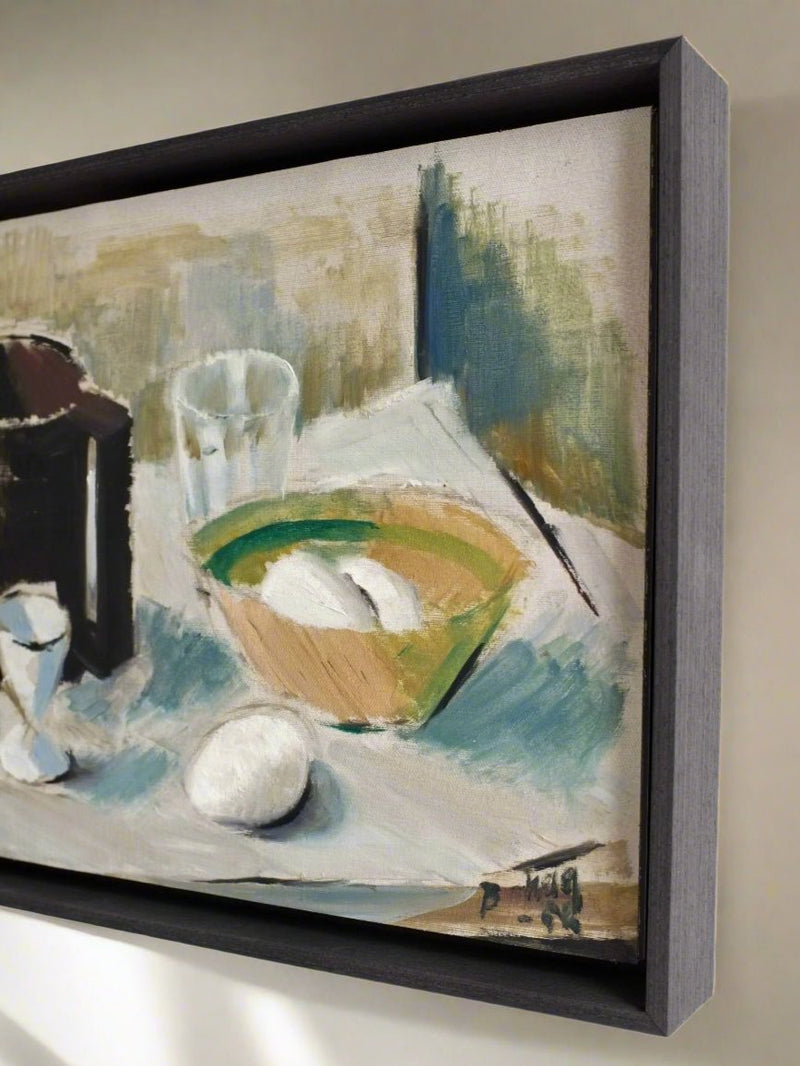 A side view of the Vintage Still Life Oil Painting "Breakfast" from the 1960s by Veter Vintage. The artwork, housed in a floating frame, depicts a breakfast motif with a glass, a bowl containing two white objects, and an egg resting on a tablecloth. The background features abstract lines and colors that add texture to the composition. Originating from Sweden, this piece captures the essence of mid-century still life art.