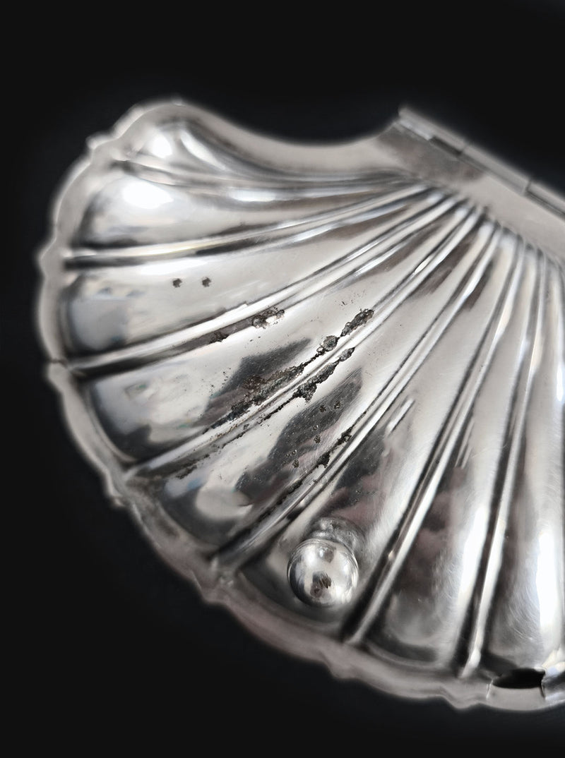 Silver shell-shaped decorative box with ribbed surface detail
