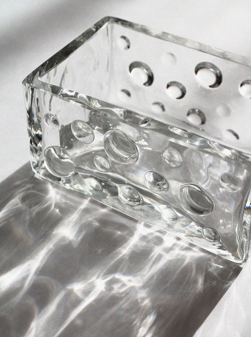 Close-up detail of crystal bubble bowl showing circular air inclusions