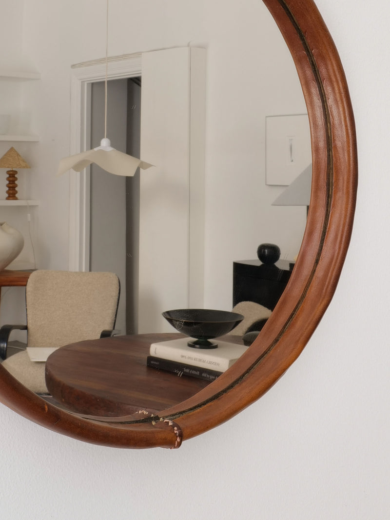 Saddle leather mirror frame detail showing warm brown patina
