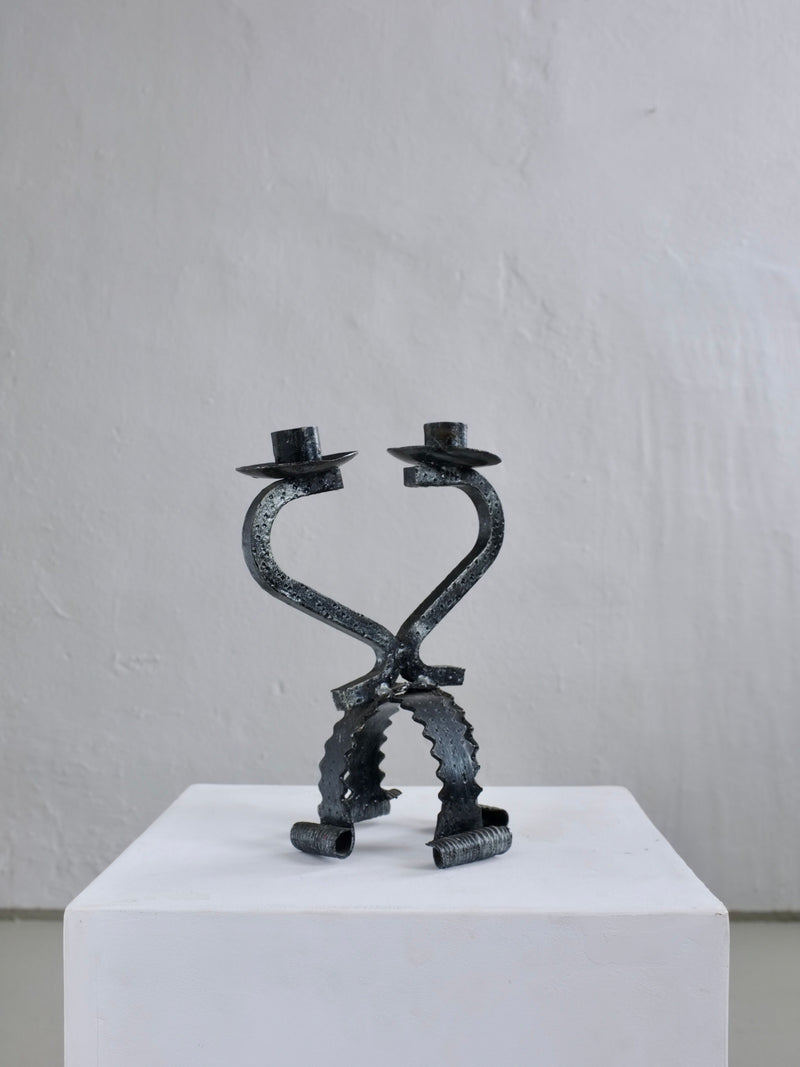 Brutalist iron candle holder with heart-shaped sculptural legs