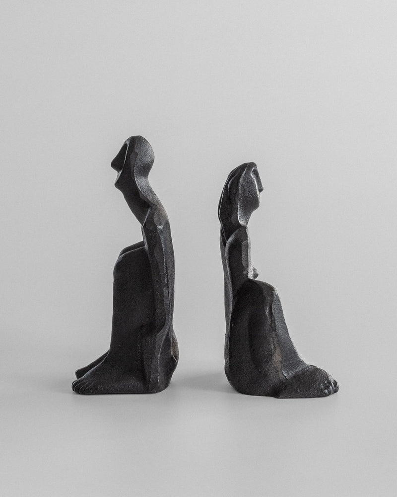 The Male and Female Sculptures by Marita Norin for Spigel are cast-iron figures seated back to back. The minimalist design highlights their curves and contours, making them ideal bookends against a plain backdrop.