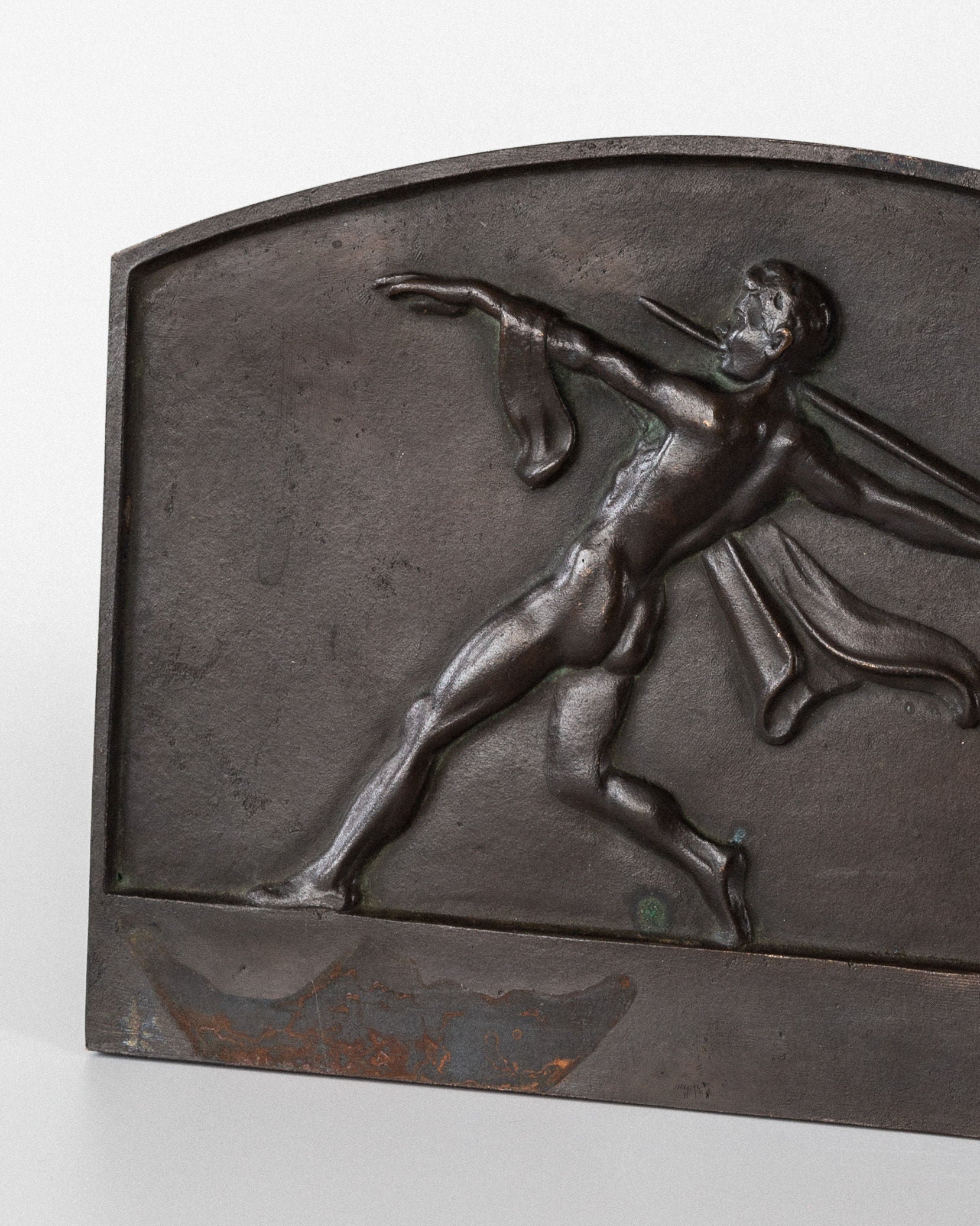 The Spigel Art Deco Bronze Wall Relief is an elegant piece featuring a nude male figure in motion with a spear-like object and a flowing cloth, set against an arch-shaped backdrop that embodies timeless Art Deco style.