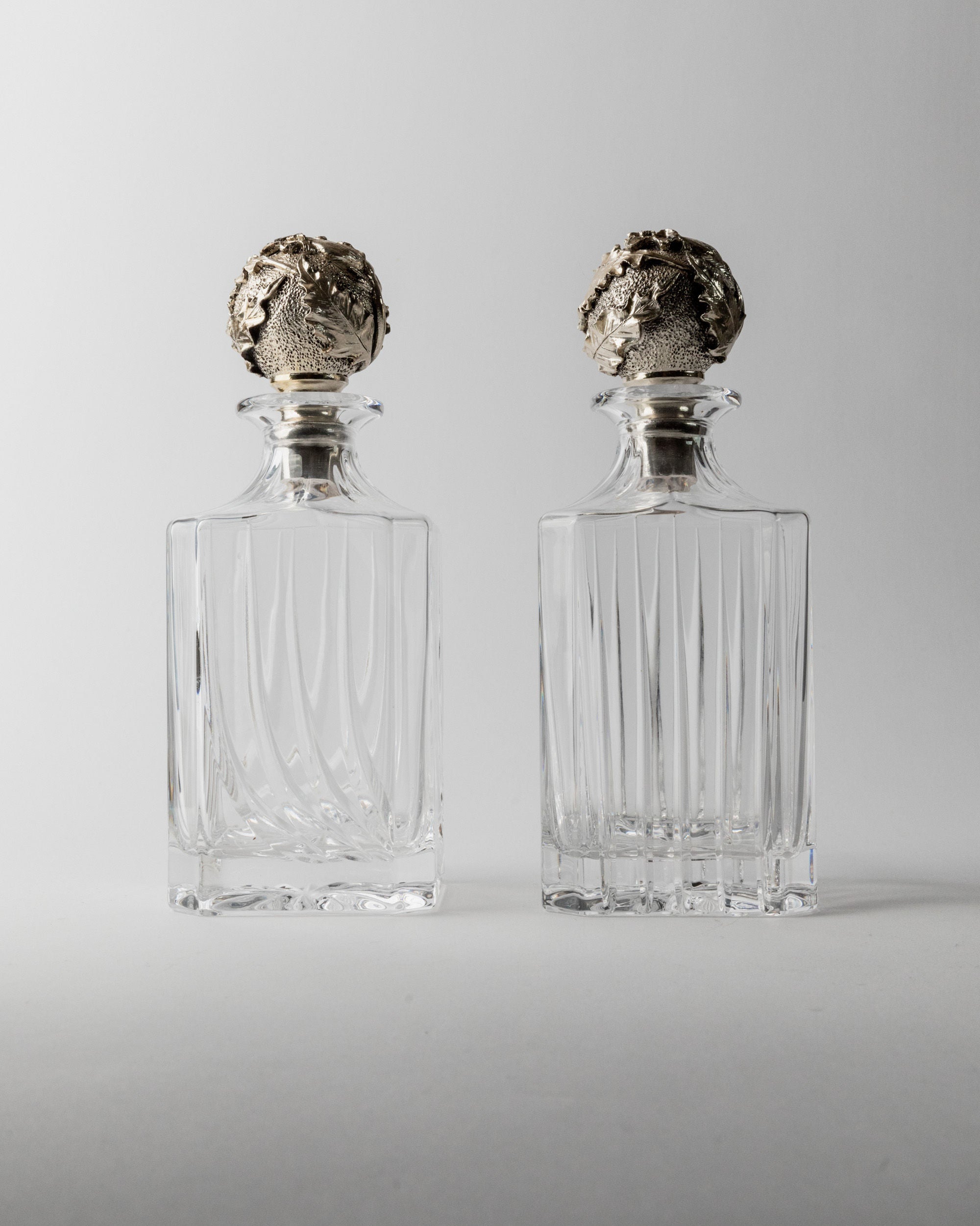 Two vintage crystal decanters with ornate silver stoppers, Italy 1950s