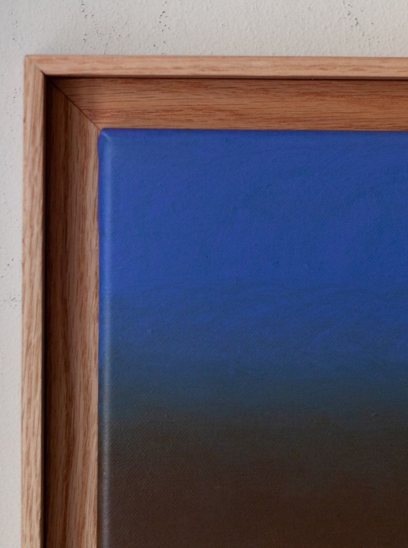 Close-up of "Untitled, 2024" painting by Rebecca von Matérn with gradient shades of blue, encased in a 36x36 cm hard wax oiled oak shadow frame. The frame's corner is visibly detailed against a plain wall.