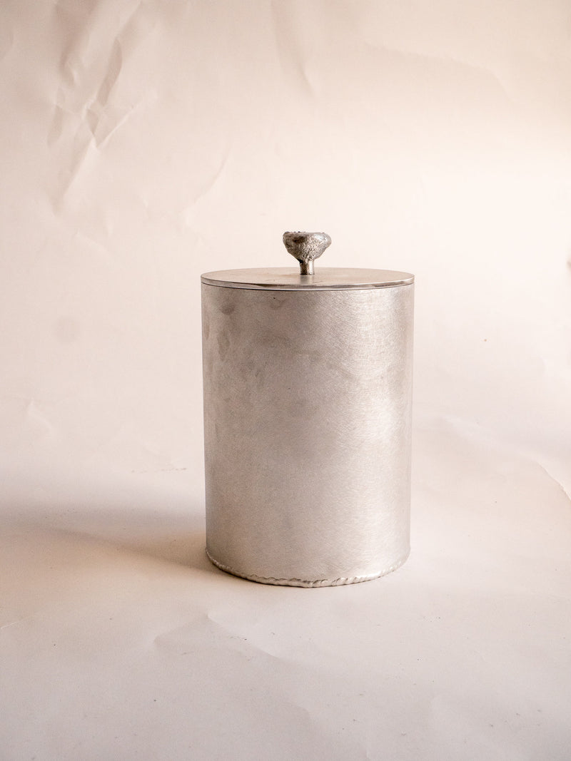 Cylindrical beige ceramic desk bin with textured lid and knob handle