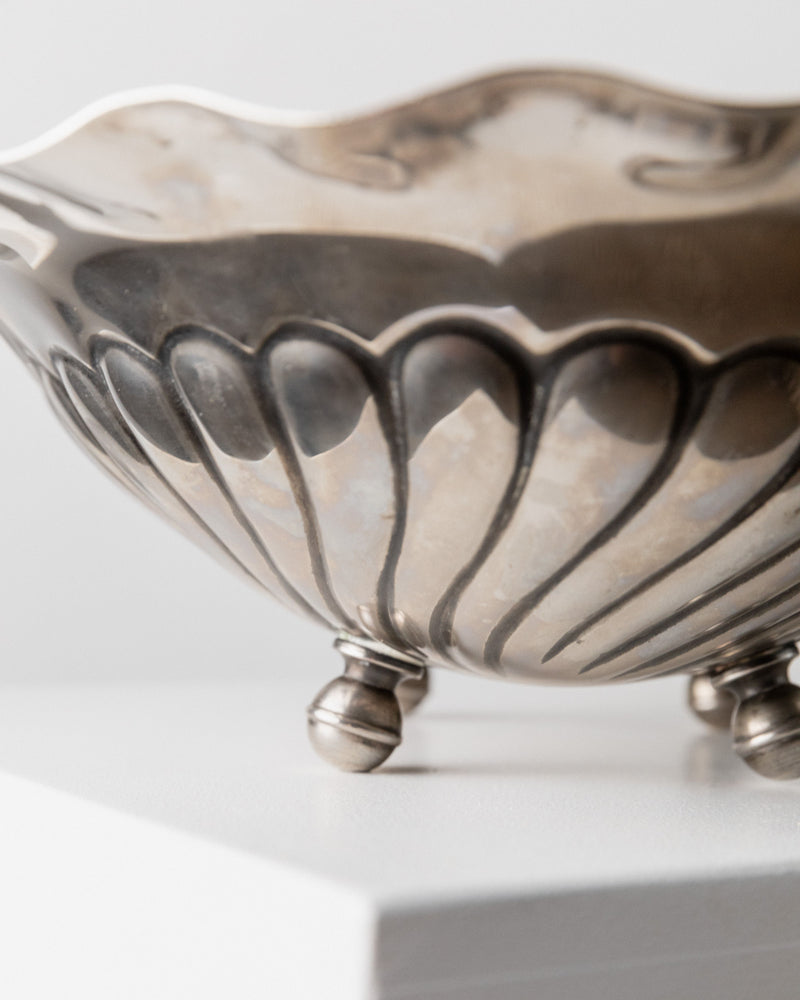 Close-up of a vintage Bottega Jacobs Large Silver-plated Bowl from Italy, 1940s. Featuring ornate scalloped detailing and reflective surface, it rests elegantly on three small, rounded feet against a plain background.