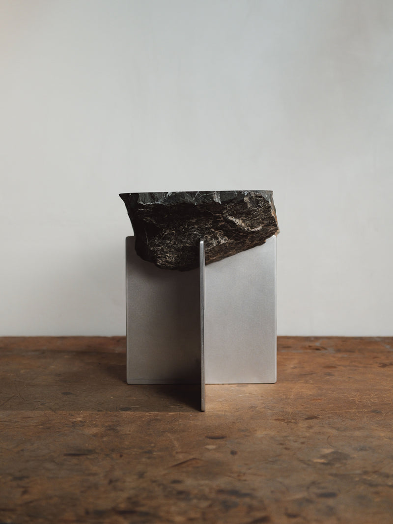 Large hybrid side table with raw black stone slab on metal base