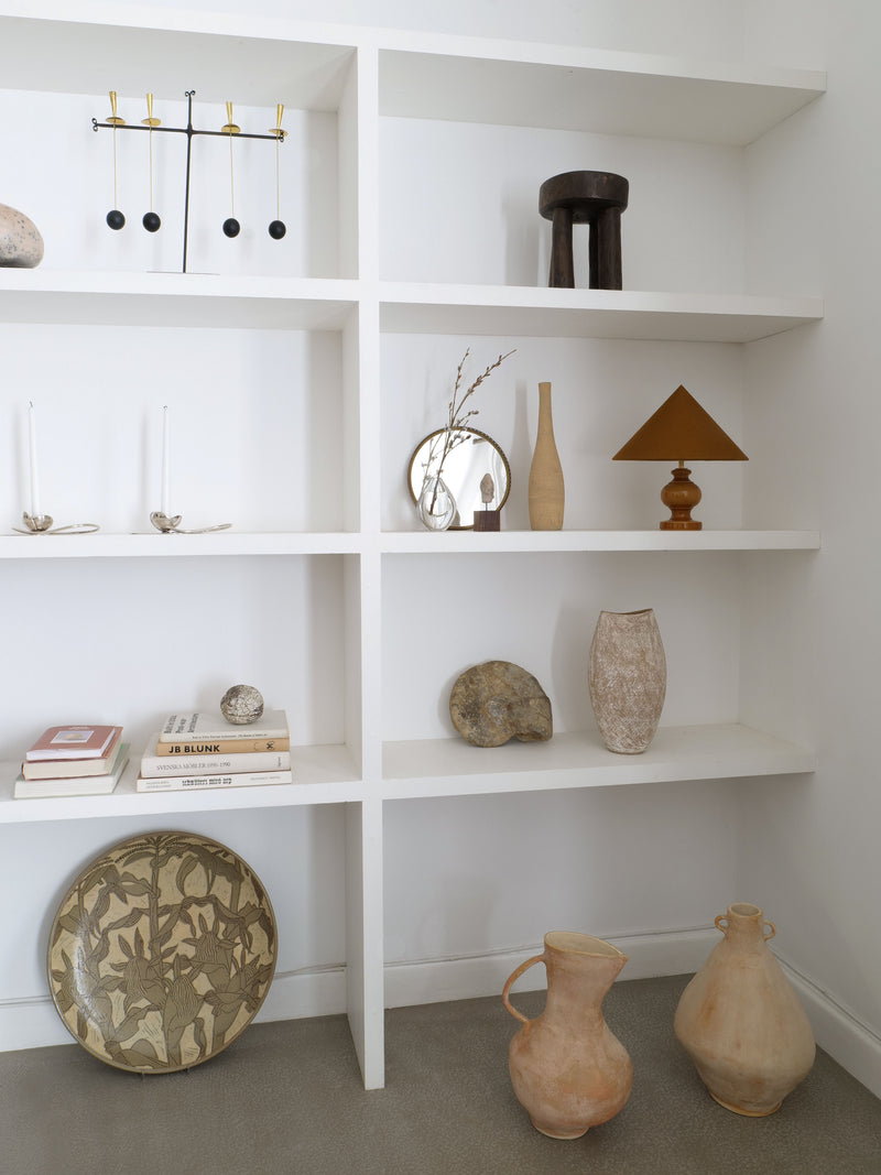 Sculptural ceramic table lamp styled in modern white bookshelf