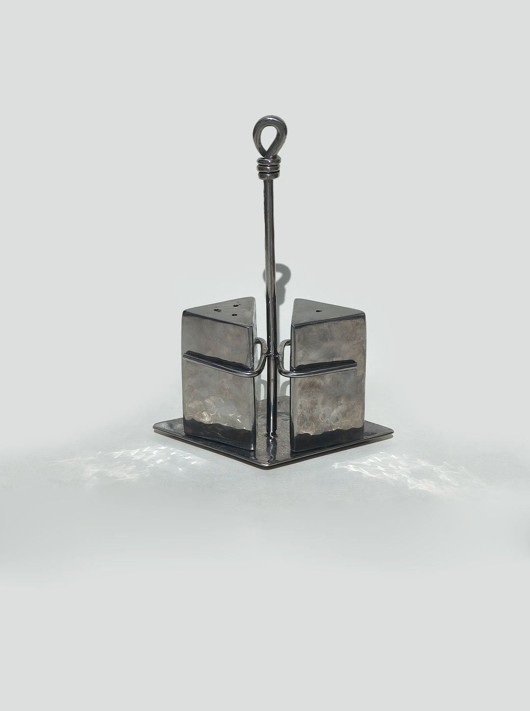 Modern metallic salt and pepper shaker set with wire caddy