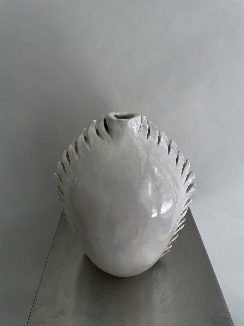 Round spiky vase made of clear glass with textured surface