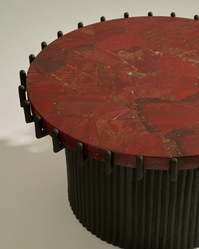Red marble top detail of Sentinel coffee table with black cylindrical base