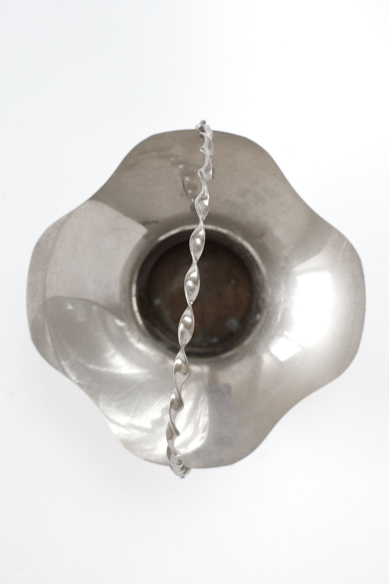 Clear glass decorative bowl with twisted silver handle detail