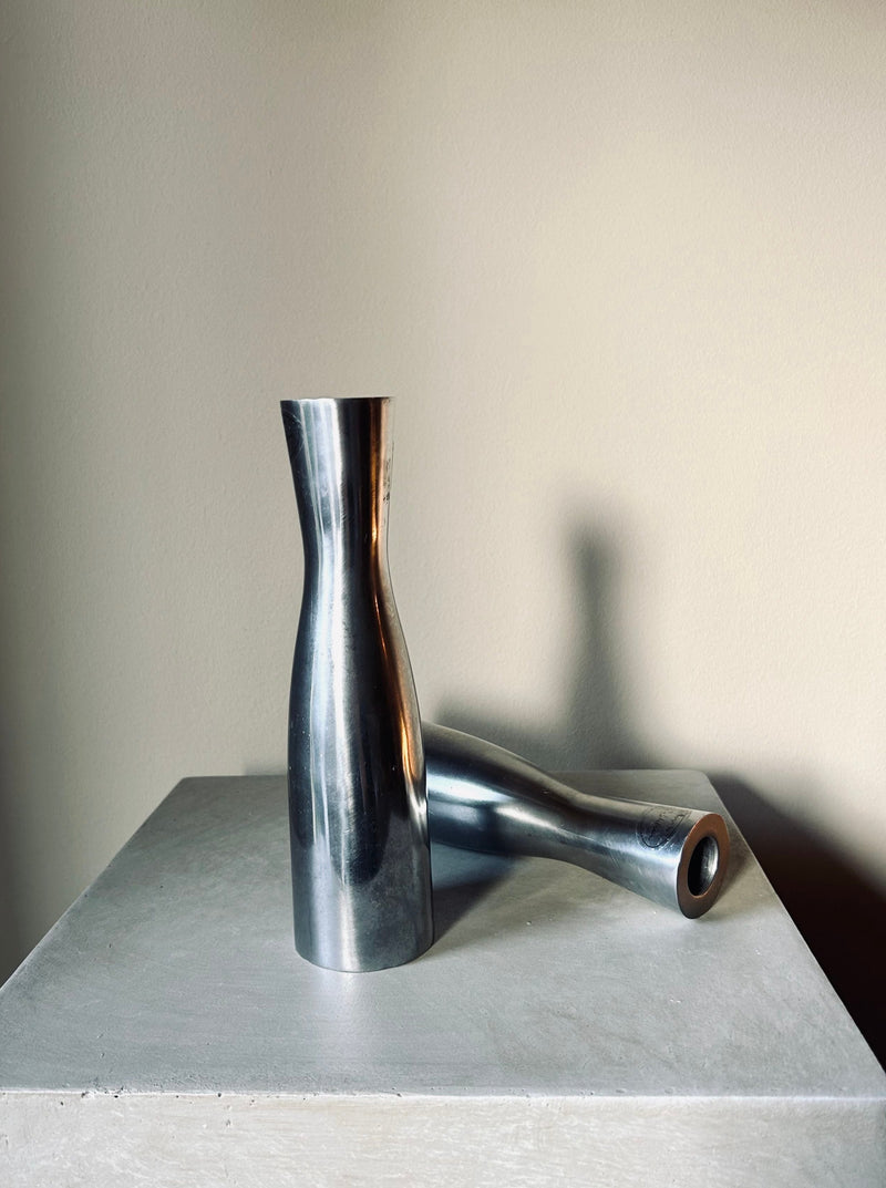 Set of 2 polished steel candlesticks designed by Erika Pekkari