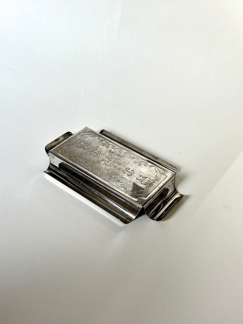Luxurious silver butter dish with ornate detailing and vintage-inspired charm