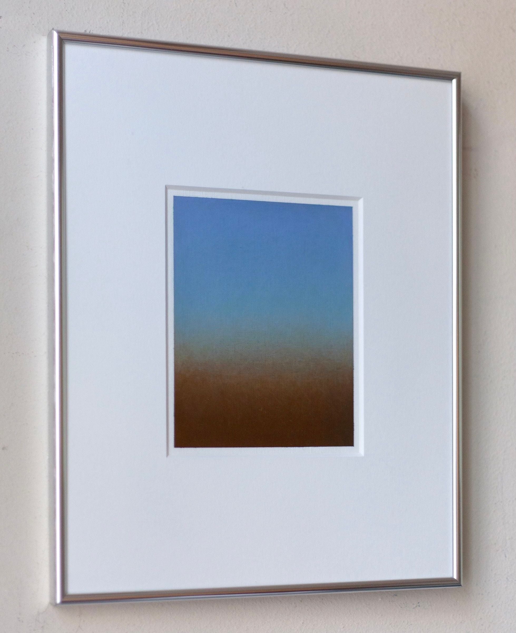 Rebecca von Matérn's 'Untitled' Painting, 2024 showcases a gradient from blue to brown. It is signed and elegantly framed in silver aluminum, ideal for displaying on a light-colored wall.