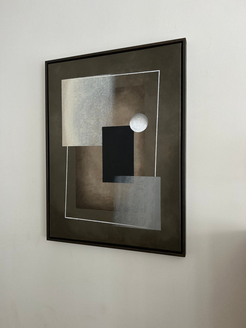 Framed abstract geometric painting with black rectangle and white circle on muted tones
