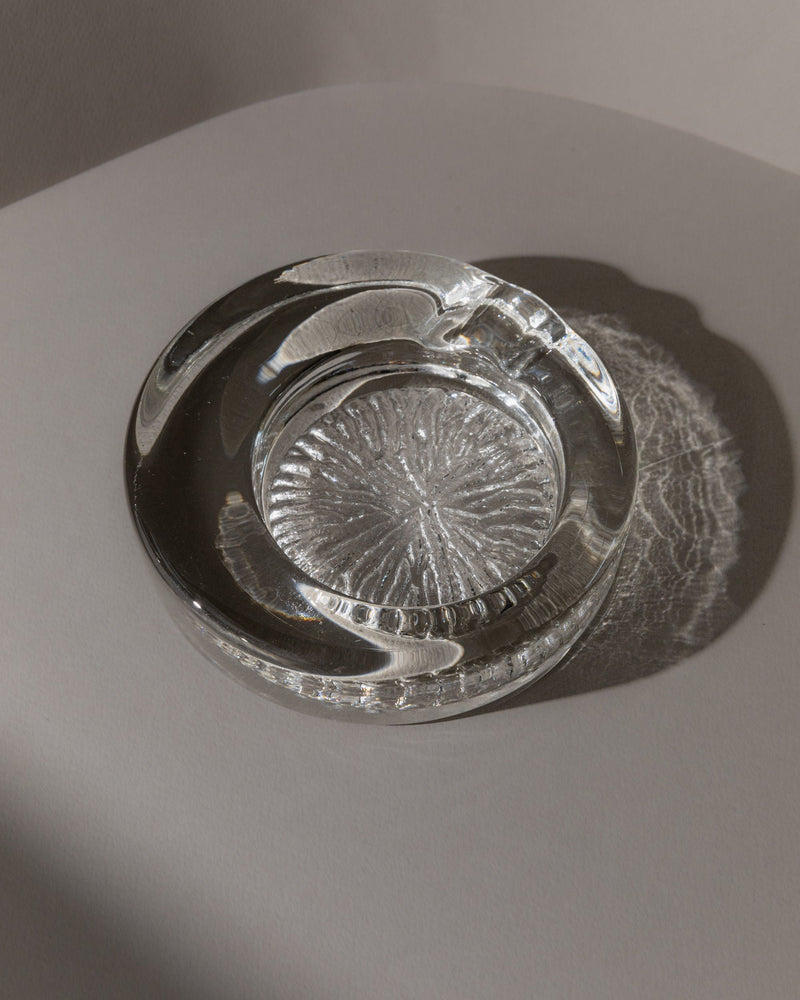 Clear Murano glass ashtray with radial pattern, overhead view