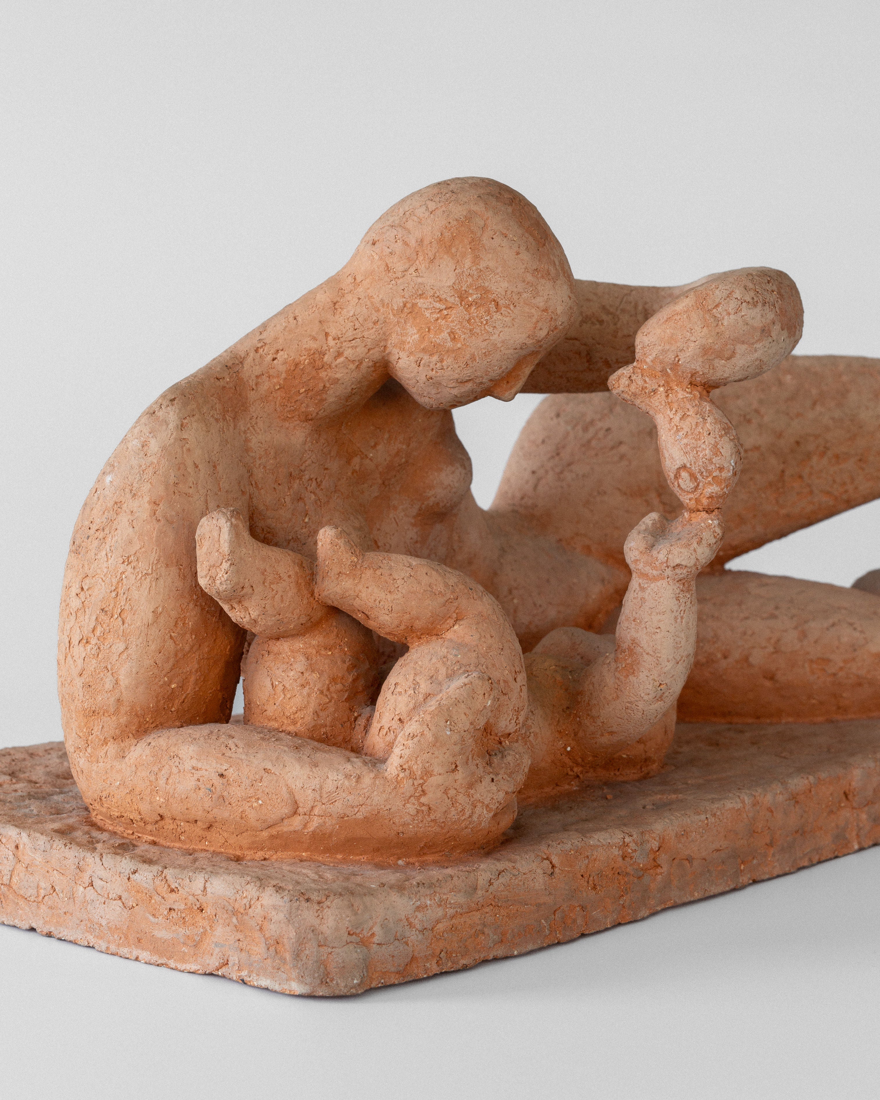 The "Modernist Terracotta Sculpture by Bengt Amundin, 1950s" from Spigel features a Swedish modernist style with an unglazed terracotta figure, depicting a seated female breastfeeding a child while holding an object. The textured surface enhances the natural beauty of the piece.