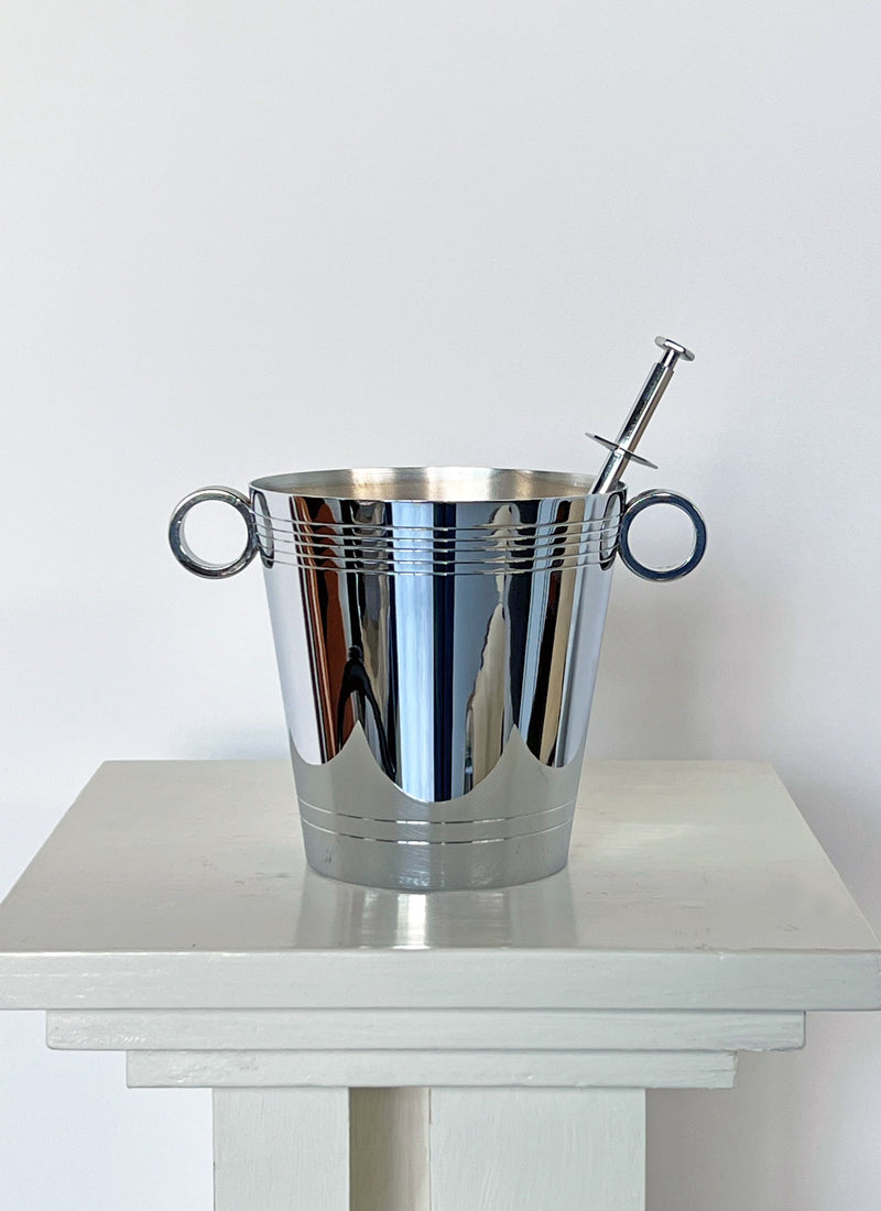 Polished chrome ice bucket with dual handles and ice picker